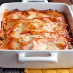 a casserole dish with cheese and vegetables in it