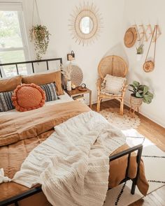 a bed room with a neatly made bed and two wicker chairs next to it