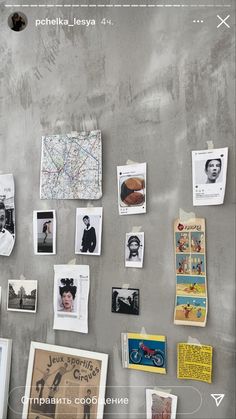 a refrigerator covered in pictures and magnets next to a wall with writing on it