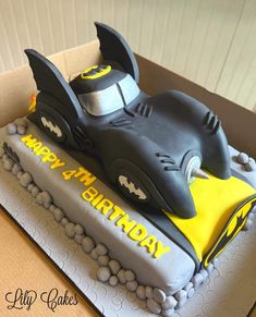 a birthday cake for a child's first birthday with a batman car on top