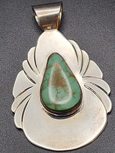 Gorgeous Turquoise Pendant signed by maker, MS. 2 inches long and 1.5 inches wide. Stone and setting are in great shape. Southwestern Turquoise Necklace With Large Green Pendant, Southwestern Green Turquoise Necklace With Large Pendant, Green Turquoise Necklace With Large Southwestern Pendant, Southwestern Green Jewelry With Large Pendant, Green Southwestern Jewelry With Large Pendant, Southwestern Style Green Jewelry With Large Pendant, Collectible Green Turquoise Pendant Necklace, Unique Green Turquoise Collectible Necklace, Vintage Green Turquoise Necklace With Large Pendant