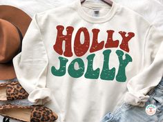 a sweater with the words holly jolly on it next to leopard print shoes and hat