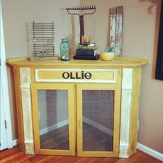 an old wooden cabinet with the word ollie written on it's door and some other items sitting on top