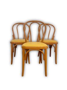 three wooden chairs sitting next to each other