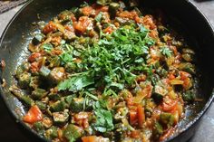 a pan filled with vegetables on top of a table