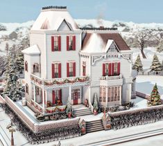 a large white house with red shutters and christmas decorations