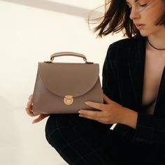 In a world of constantly changing trends and fashion, the "Taistra" messenger bag for women always remains a faithful symbol of your elegance and taste. Dimensions: 9,1х5,5х3,2 in / 23x14x8 cm. Material: genuine leather. Colors: black, brown (tobacco), gray (French grey). Includes a detachable and adjustable shoulder strap. Trendy Everyday Saddle Bag With Detachable Handle, Trendy Top Handle Saddle Bag For Travel, Trendy Saddle Bag With Detachable Handle For Everyday Use, Trendy Saddle Bag With Detachable Handle For Daily Use, Office Saddle Bag With Removable Pouch, Handheld Saddle Bag For Everyday Use, Beige Satchel Flap Bag, Beige Briefcase With Detachable Handle, Trendy Daily Use Flap Bag With Top Carry Handle