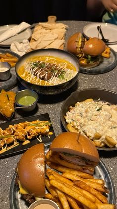 a table topped with plates filled with different types of food and condiments on top of it