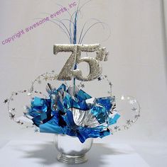 a silver and blue centerpiece with the number twenty five