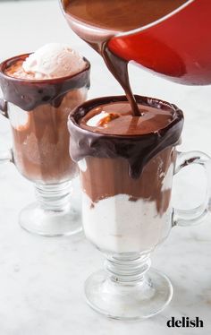 two glasses filled with hot chocolate and ice cream being drizzled over them