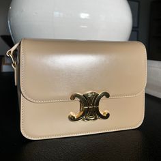 The Bag Features An Adjustable Leather Shoulder Strap With Gold Hardware, And A Matching Gold Press Lock On The Crossover Flap. This Opens To A Partitioned Beige Leather Interior With Zipper And Patch Pockets. Celine Bags, Leather Interior, Beige Color, Gold Hardware, Crossover, Patch Pocket, Calf Skin, Shoulder Strap, Bag Lady