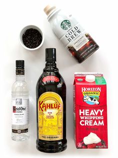 ingredients to make an ice cream sundae laid out on a white surface, including milk, yogurt, and coffee