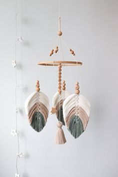 two seashells hanging from a string with tassels