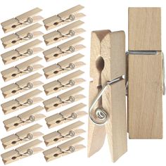 a bunch of wooden clothes pegs are next to a pair of scissors and a piece of wood