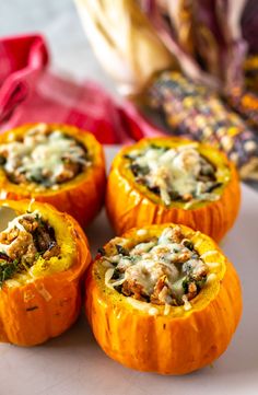 four stuffed pumpkins are sitting on a plate