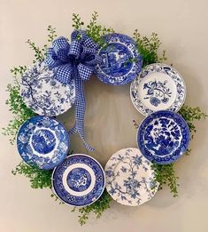 a wreath made out of blue and white plates