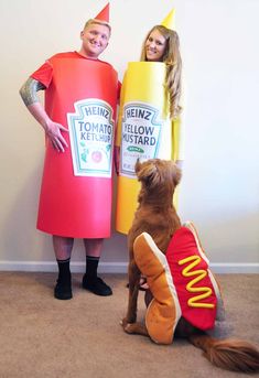 two people and a dog are dressed up as hotdogs, ketchup, and mustard