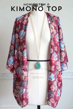 a mannequin wearing a pink and blue floral kimono with pearls on it