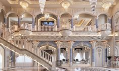 an elaborately decorated lobby with chandeliers and marble floors is seen in this image