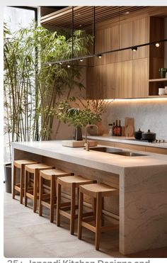 a kitchen island with stools in front of it and bamboo plants on the wall