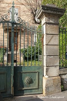 an old iron gate with a clock on it