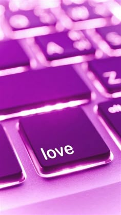 a pink keyboard with the word love on it