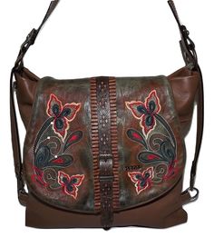 Elenco Portugal Leather Lisbon Convertible Crossbody Shoulder Bag Brown Multi - Style #4033-119 Elenco handbags are crafted in Portugal of the finest hand-stained calfskin leather. Attention to detail is given to each bag to ensure the finest quality craftsmanship including the hand-staining process, hardware selection and stitching construction. Features include fashion-forward designs in vibrant colors of blues, greens, yellows and cognac. Heads will turn with an Elenco bag on your arm! This Lisbon Convertible Crossbody from Elenco Portugal is constructed from a rich floral-embroidered top-grain leather. Features include a front flap with top-zip closure, rear exterior zip pocket and a roomy interior with zip & slip pockets. Convertible design allows the bag to be carried as a top handle Floral Embroidered Top, Shoulder Bag Brown, Embroidered Leather, Card Case Wallet, Top Grain Leather, Embroidered Top, Metallic Leather, Lisbon, Crossbody Shoulder Bag