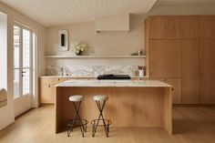 two stools are in front of the kitchen island