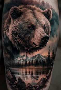 a bear tattoo on the leg with mountains and trees in the background, as well as water