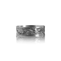 a silver ring with flowers and leaves on it