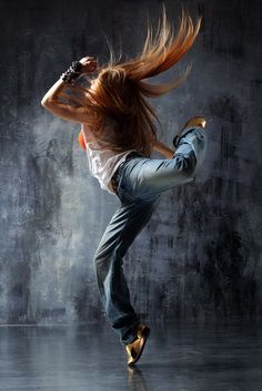 a painting of a woman dancing with her hair blowing in the wind and wearing blue jeans