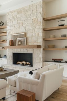 a living room filled with furniture and a fire place