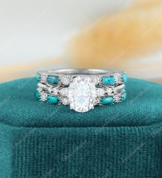 an engagement ring with turquoise stones and diamonds