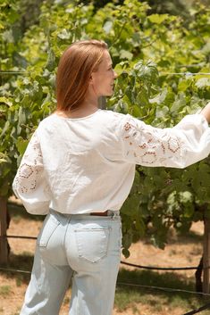 The Bekah Blouse is so dreamy! Featuring a stretchy cinched waist for a flattering silhouette and beautiful bell sleeves that can be adjusted to a cinched, billowy style. This blouse is super lightweight and comfortable, making it perfect for warm weather. The exquisite eyelet detailing adds visual interest, ensuring you look and feel your best. Whether you're dressing up for a special occasion or keeping it casual, this versatile blouse is a must-have addition to your closet! Malibu Collection Fitted Blouse For Spring Gatherings, Chic Peasant Top With Flowy Fit And Puff Sleeves, Chic Flowy Peasant Top With Puff Sleeves, Flowy Puff Sleeve Tops With Elastic Sleeves, Chic Blouse With Elastic Sleeves For Brunch, Lantern Sleeve Blouse With Elastic Sleeves For Brunch, Flowy Puff Sleeve Blouse With Smocked Back, Spring Blouse With Gathered Sleeves For Gatherings, Flowy Puff Sleeve Blouse For Brunch