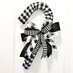 a black and white bow hanging on the front door