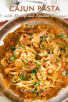 a pan filled with pasta and meat covered in sauce, garnished with parsley