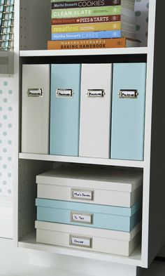 a white book shelf with blue and white file cabinets next to books on top of it