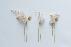 The Lily of the Valley Bridal Hair Pins is the perfect accessory for the bride who wants to channel the natural, feminine allure of the lily. Whether pinned into an elegant updo or cascading down soft, romantic waves, this captivating piece will make you feel like a true vision of loveliness. Embrace the purity and joy that the lily of the valley represents, and let its exquisite elegance elevate your entire bridal ensemble. This timeless, enchanting hair pin is a must-have for the bride who wan Handmade Gold Hair Accessories For Wedding, Elegant Flower Hair Accessories For Wedding, Gold Hair Accessories For Wedding, Elegant Gold Hair Accessories For Wedding, Delicate Adjustable Wedding Hair Accessories, Dip Resin, Romantic Waves, Handmade Wedding Jewellery, Bridal Hair Pins Pearl