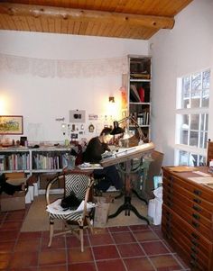 a room filled with lots of clutter and furniture next to a book shelf full of books