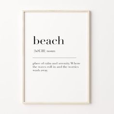 a white framed poster with the words beach in black and white font, on a wall