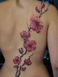 the back of a woman's body with pink flowers painted on her stomach and chest