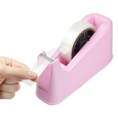 a person holding a roll of tape in a pink holder