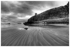 a black and white photo of the beach