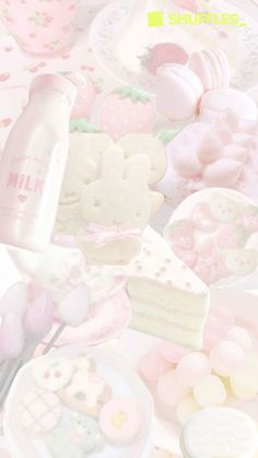 a table topped with lots of pink and white desserts