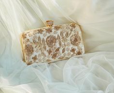 Thank you for visiting my shop! --- **Handcrafted Zardozi Embroidered  Floral Clutch - Luxurious & Elegant Design** Add a touch of timeless elegance to your wardrobe with this exquisite handmade clutch. Adorned with intricate gold floral embroidery on a soft, velvety base, this clutch is the epitome of sophisticated luxury. The delicate metallic flower motifs and stunning craftsmanship make it the perfect statement accessory for weddings, parties, or special occasions. **Features  **Color Champagne with gold floral embroidery - **Material High-quality velvet with gold-tone metal accents - **Luxurious Embroidery Hand-stitched golden floral patterns for a classic, ornate look - **High-Quality Craftsmanship Expertly crafted to ensure durability and a premium finish - **Chic Rose Clasp Topped Gold Rectangular Clutch With Zari Work, Gold Evening Bag With Handwork For Reception, Gold Handwork Evening Bag For Reception, Festive Gold Hand Embellished Clutch, Festive Gold Hand-embellished Clutch, Gold Bag With Resham Embroidery For Reception, Gold Evening Bag For Diwali, Beige Embroidered Evening Clutch, Beige Clutch Evening Bag For Festive Occasions