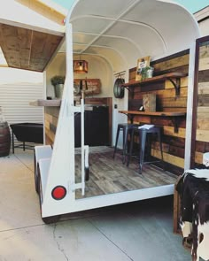 the back end of a trailer that is made out of wood and has shelves on it