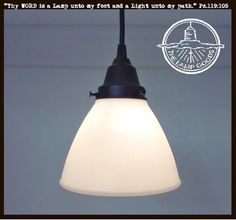 a white light hanging from the ceiling with a quote above it that reads, why world is a lamp post and a light up my wall?