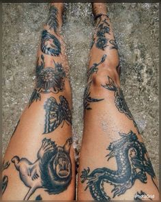 the legs and ankles of a person with tattoos on them