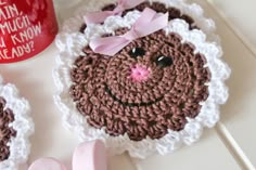 there is a crocheted cupcake with a pink bow on it next to marshmallows