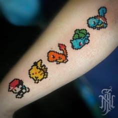 an arm with some pixel tattoos on it